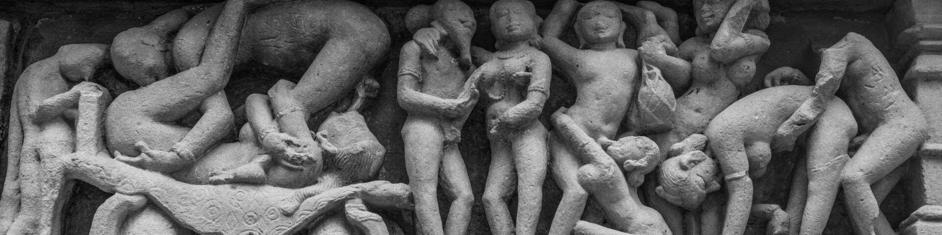 A stone sculpture of multiple figures in various poses, likely depicting a mythological or historical scene.