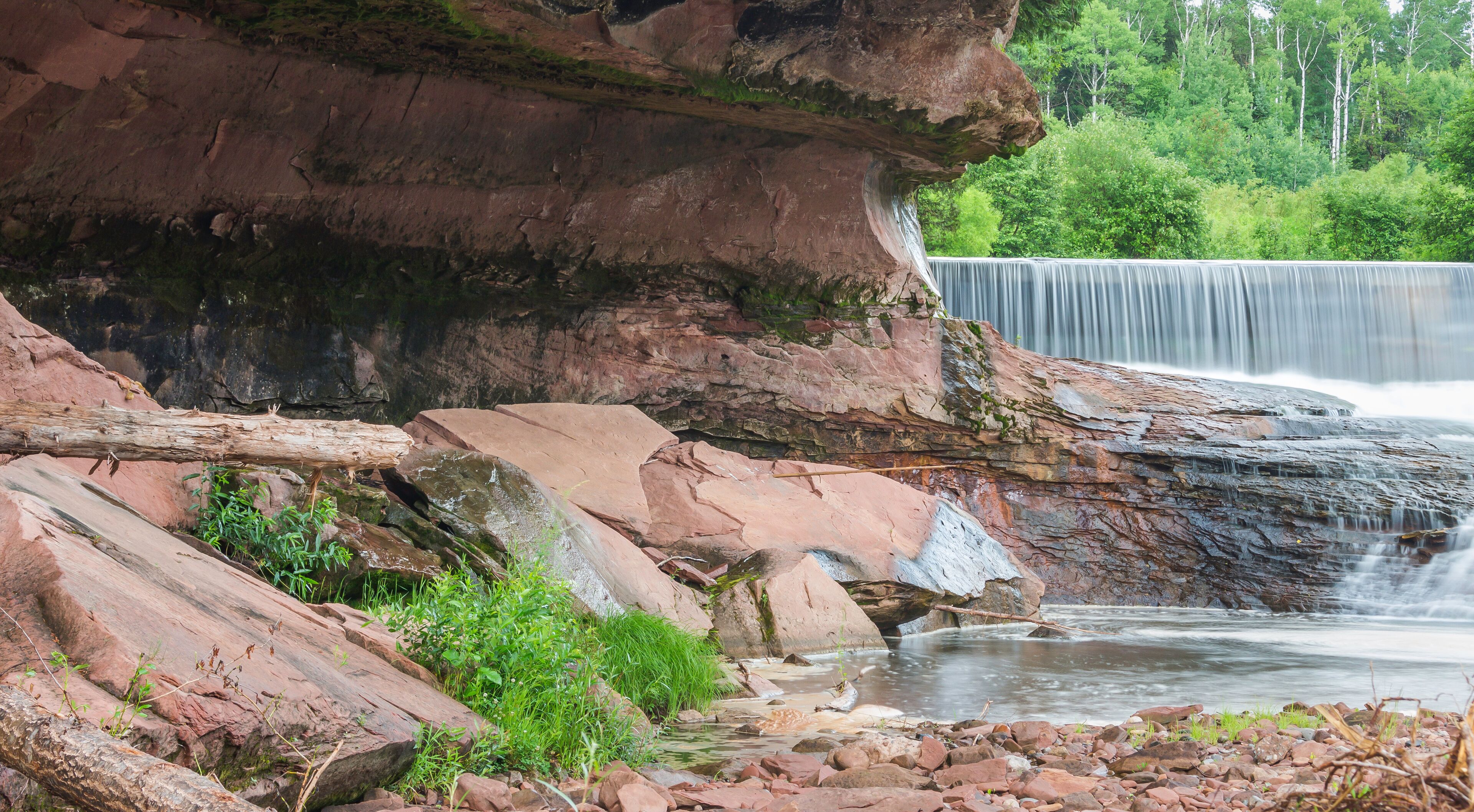 Small Waterfall Surrounded by Beautiful, Massive Red Rock Cliffs and Walls Long Exposure