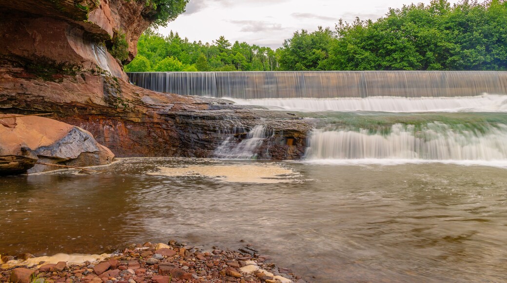 Small Waterfall Surrounded by Beautiful, Massive Red Rock Cliffs and Walls Long Exposure