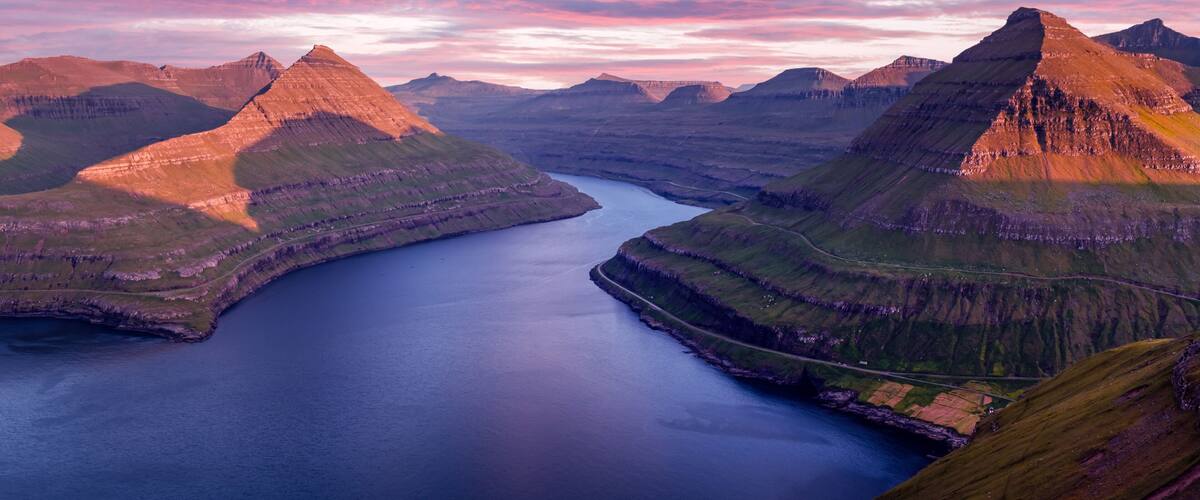 A mountainous landscape with a large body of water surrounded by hills.