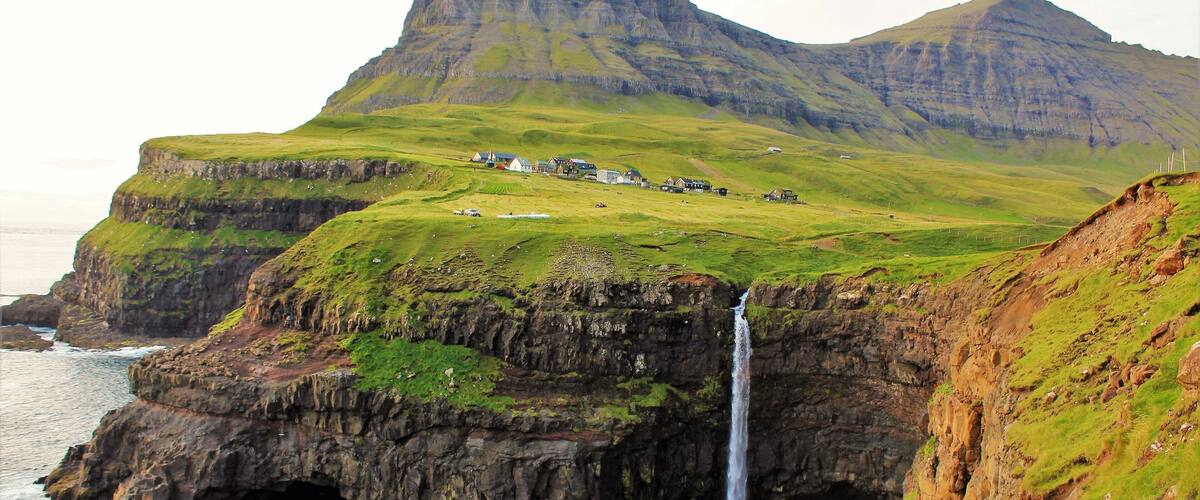 I took this photo on August 27th in the Faroe Islands. This waterfall is one of the most picturesque and well-visited sights there. And one of the highlights of my trip! It was a dream to visit the Faroes and especially this waterfall. Am so glad I finally did :). And while popular with photographers it is still quite isolated! And compared to the waterfalls of Iceland it is not nearly as popular. Same with the Faroe Islands as a whole. And there was just a few other tourists when I was there at sunset. Also, before the completion of a tunnel in about 2006 this waterfall was even less visited as one had to travel over the mountains to get there. A much harder journey. But the scenery is incredible on the way! And even more so when you are there :).