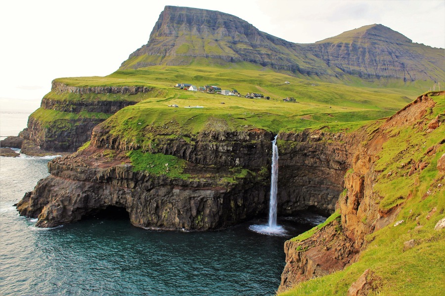 I took this photo on August 27th in the Faroe Islands. This waterfall is one of the most picturesque and well-visited sights there. And one of the highlights of my trip! It was a dream to visit the Faroes and especially this waterfall. Am so glad I finally did :). And while popular with photographers it is still quite isolated! And compared to the waterfalls of Iceland it is not nearly as popular. Same with the Faroe Islands as a whole. And there was just a few other tourists when I was there at sunset. Also, before the completion of a tunnel in about 2006 this waterfall was even less visited as one had to travel over the mountains to get there. A much harder journey. But the scenery is incredible on the way! And even more so when you are there :).