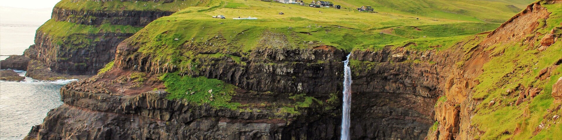 I took this photo on August 27th in the Faroe Islands. This waterfall is one of the most picturesque and well-visited sights there. And one of the highlights of my trip! It was a dream to visit the Faroes and especially this waterfall. Am so glad I finally did :). And while popular with photographers it is still quite isolated! And compared to the waterfalls of Iceland it is not nearly as popular. Same with the Faroe Islands as a whole. And there was just a few other tourists when I was there at sunset. Also, before the completion of a tunnel in about 2006 this waterfall was even less visited as one had to travel over the mountains to get there. A much harder journey. But the scenery is incredible on the way! And even more so when you are there :).