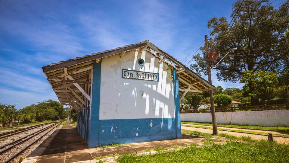 A small, weathered train station with a sign reading 'Dr. Rind.'