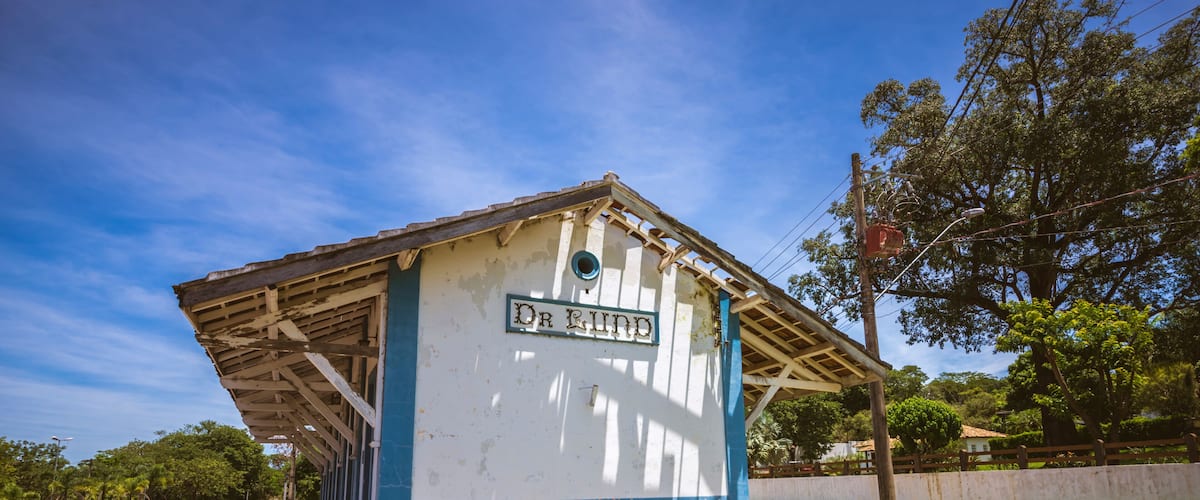 A small, weathered train station with a sign reading 'Dr. Rind.'