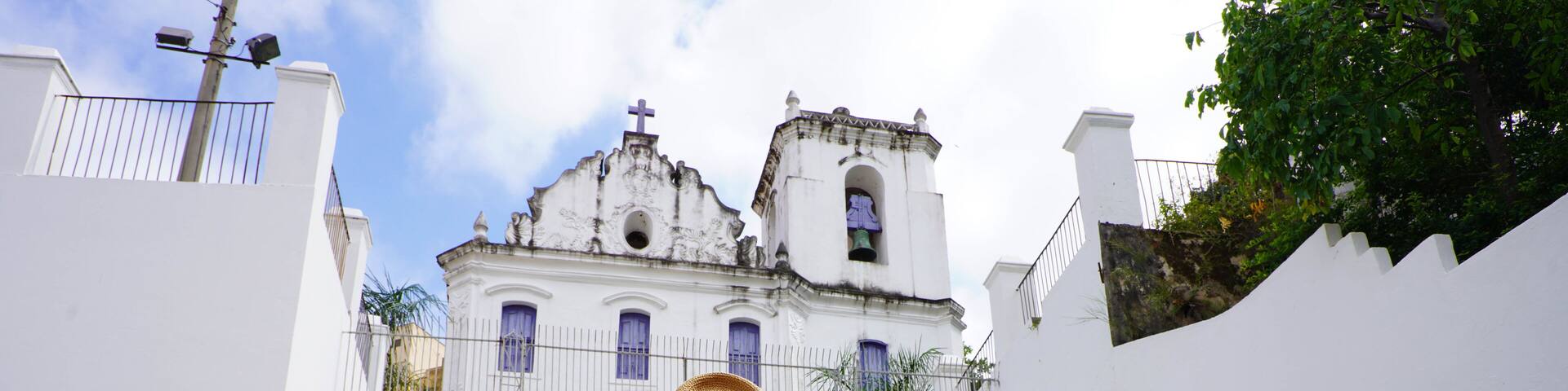 Young tourist woman visiting the church Nossa Senhora do Rosario in the historic center of Vitoria, Espirito Santo, Brazil