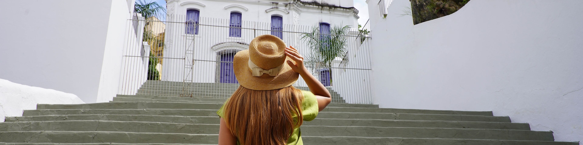 Young tourist woman visiting the church Nossa Senhora do Rosario in the historic center of Vitoria, Espirito Santo, Brazil