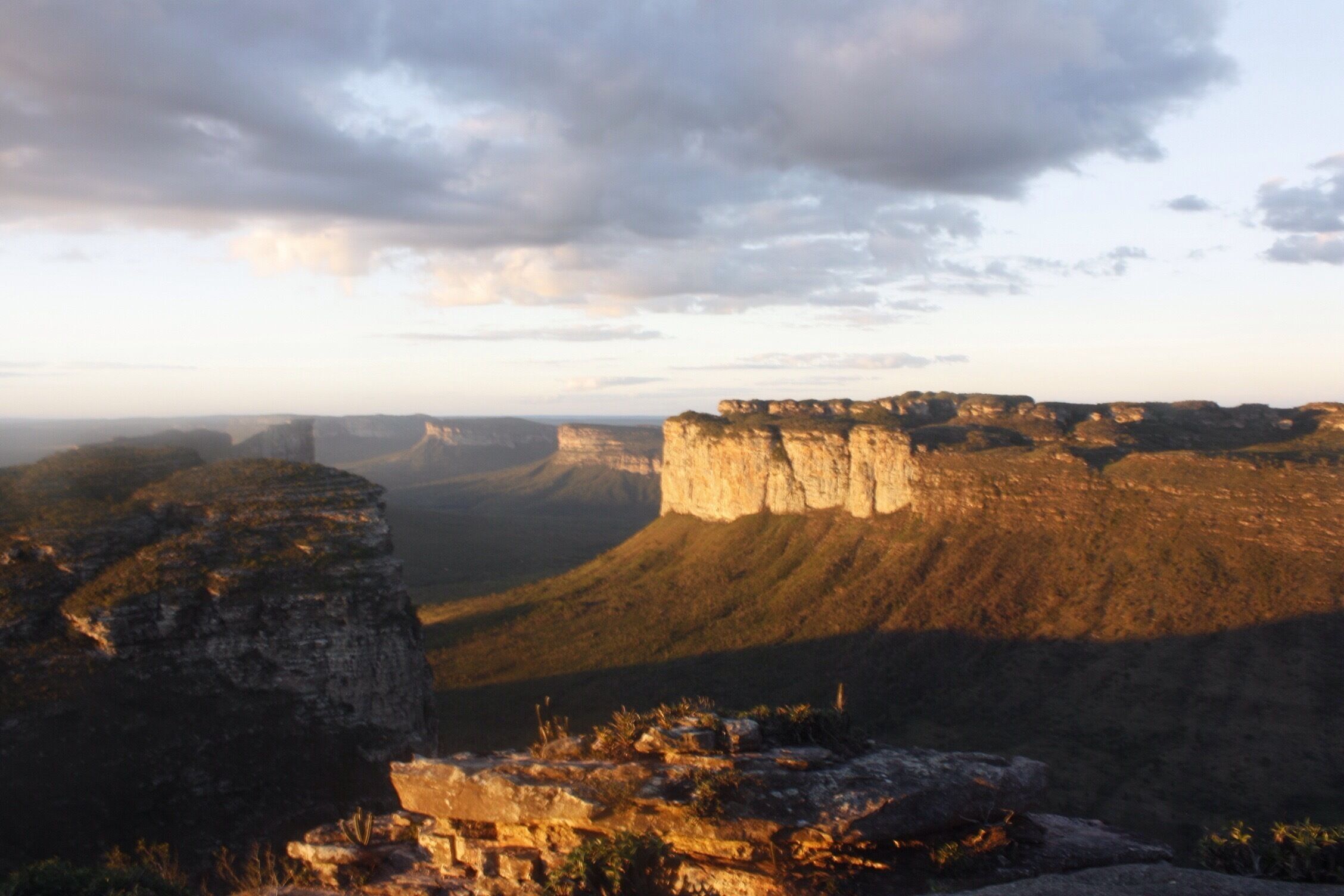 A canyon with layered rock formations and a rugged landscape.