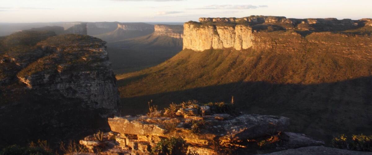 A canyon with layered rock formations and a rugged landscape.
