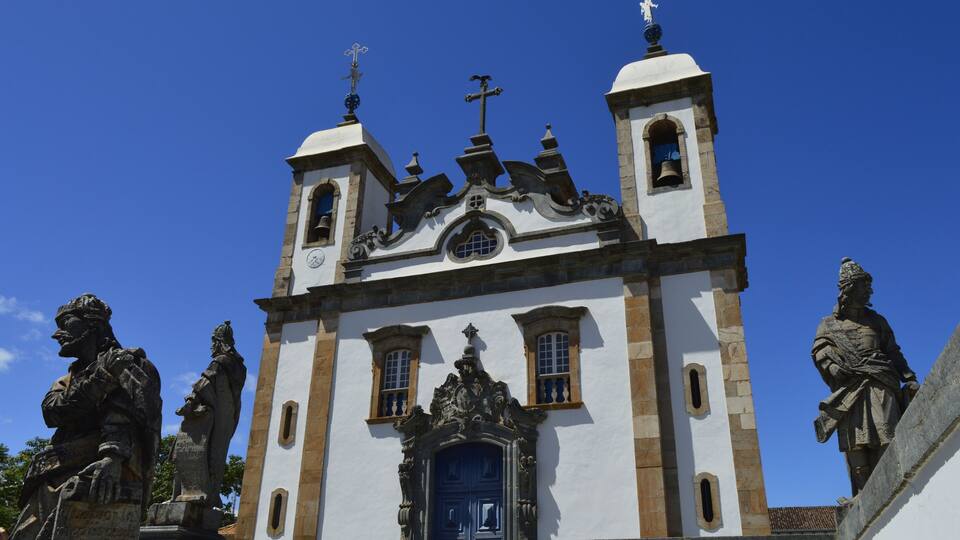 A historic church with ornate architecture, including a bell tower and statues.