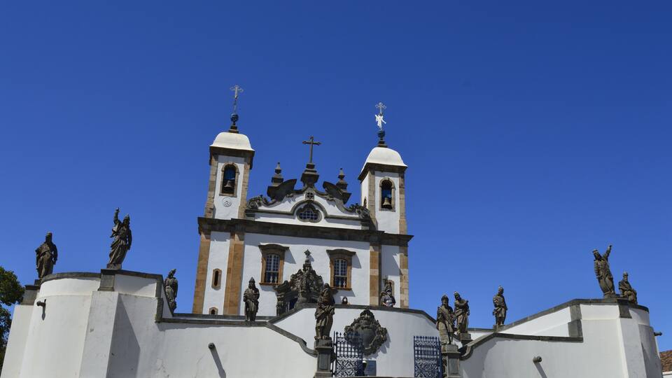 A church with two bell towers and statues on the facade.