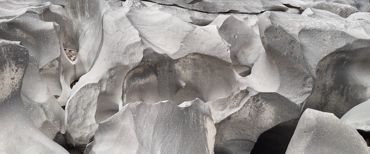 A close-up of layered rock formations with distinct textures and patterns.