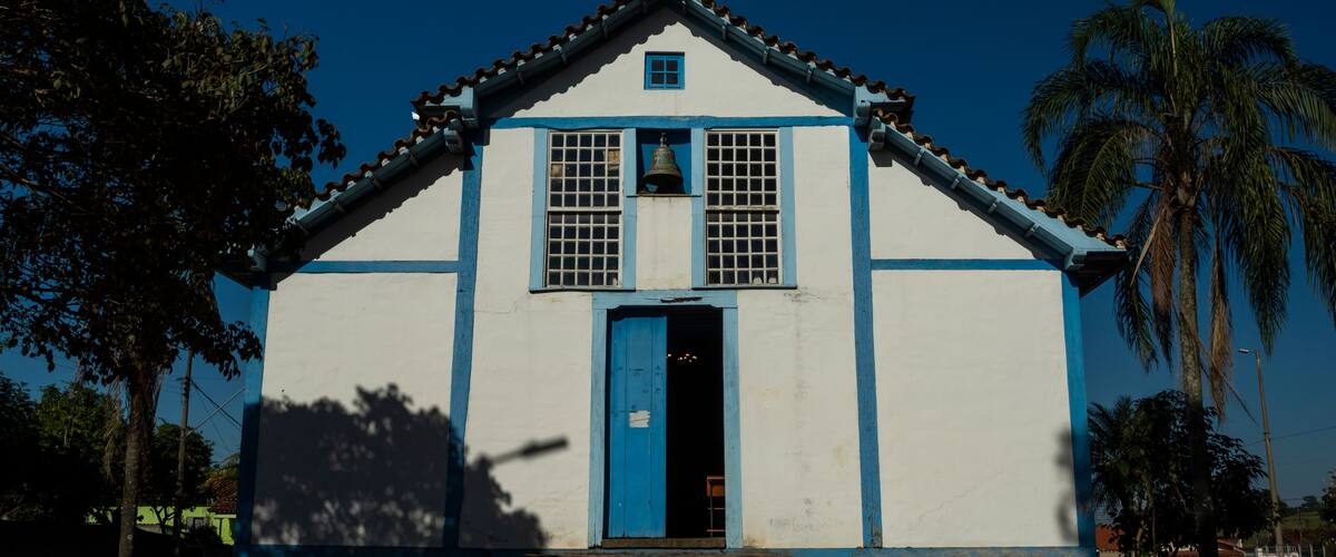 A white church with blue trim and a bell tower.