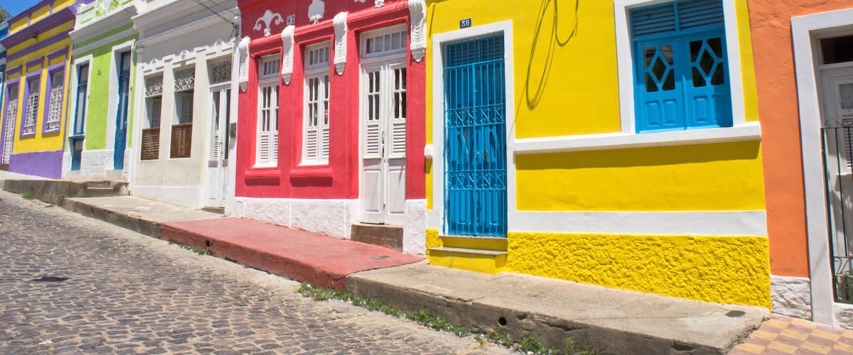A colorful street with buildings painted in bright colors like red, yellow, and green.
