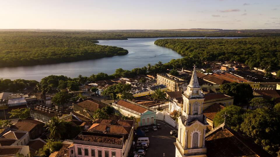 A river winding through a town with historic buildings and a prominent church.