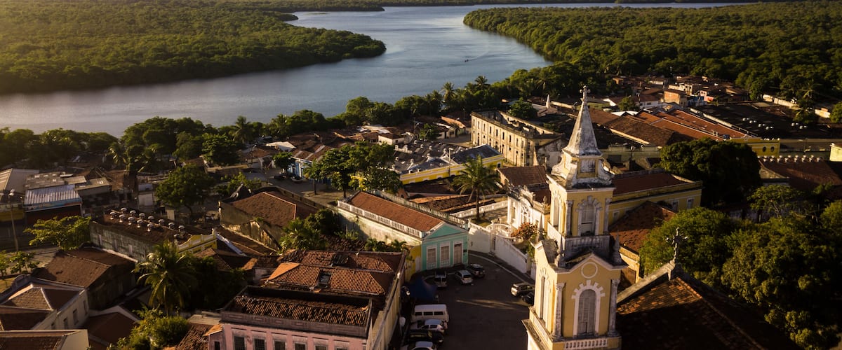 A river winding through a town with historic buildings and a prominent church.