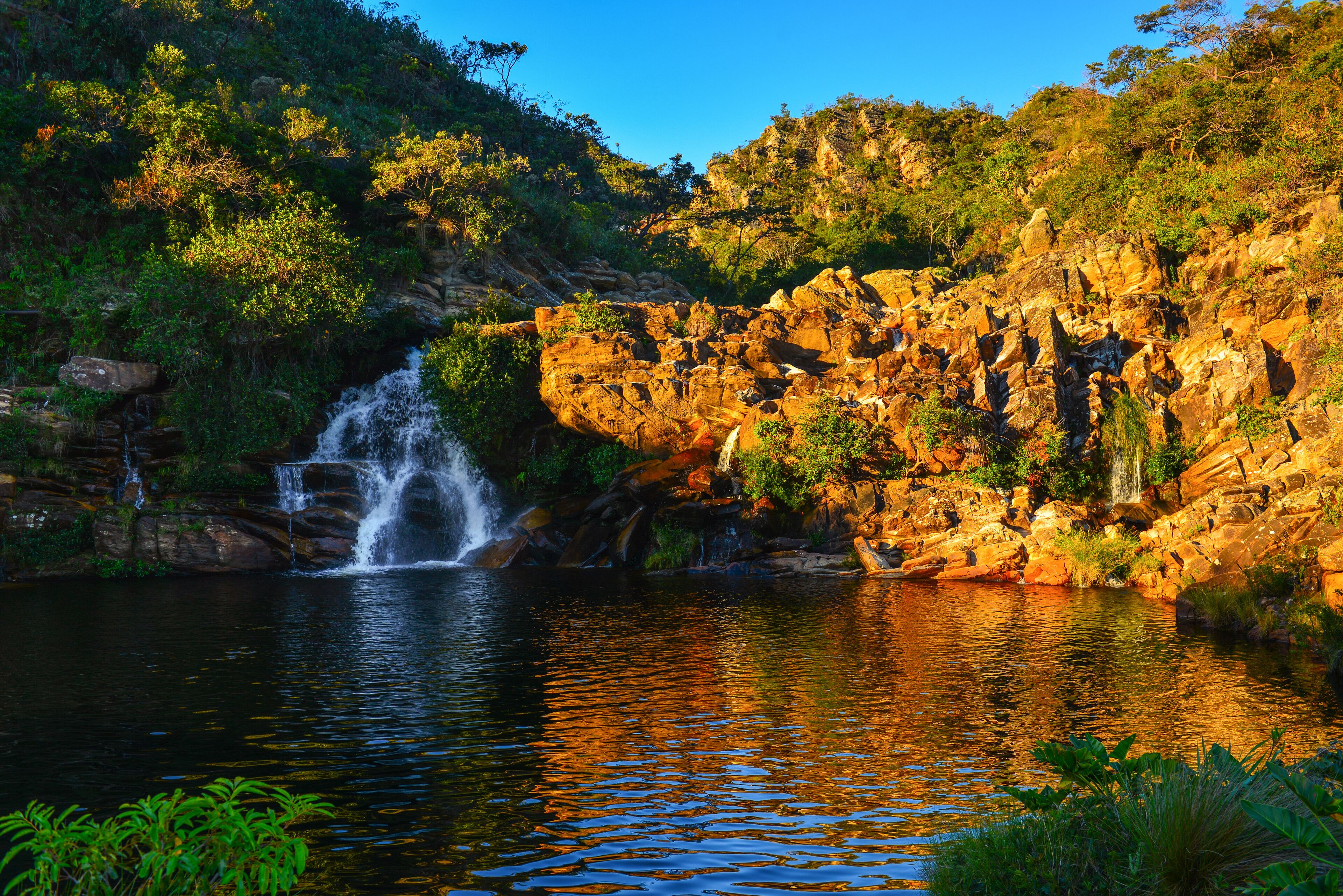Sunset on a natural pool on the Serra Morena waterfall, Serra do Cipó, Minas Gerais State, Brazil
