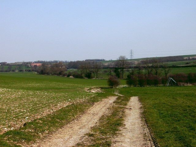 Almost there Just before the end of the path at Hatcliffe, a fairly steep climb provides this glorious view. Of interest is The Old Farm in the distance, and also the lonely children's slide in the field on the right. This was the only object of any type in that large space, and it poses the question.........why?