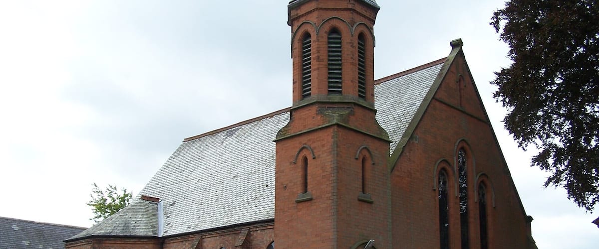 A church with a prominent tower and arched windows.