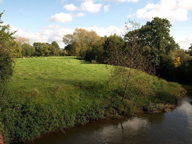 Meadow by River Tone. Looking downstream from 1000837. The bridge crosses the river on a southward meander, and the meadow lies between the river and the mill race.