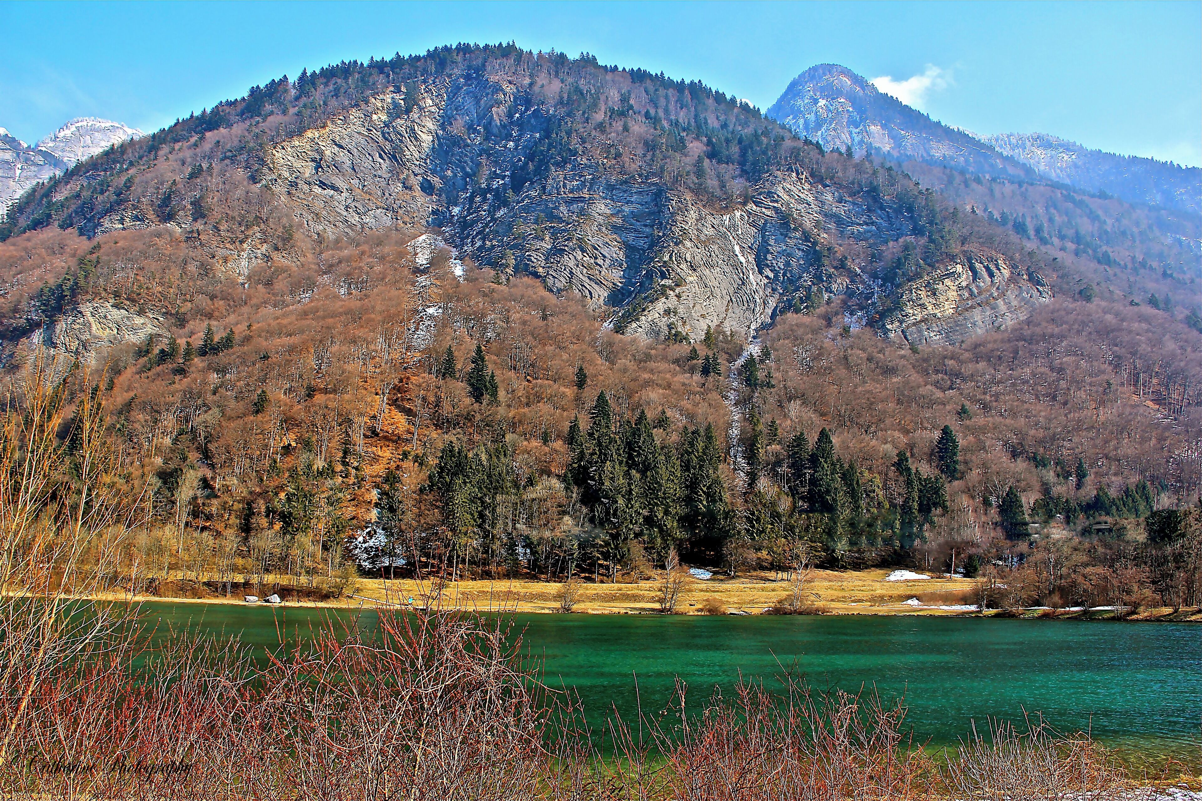 A serene and peaceful green lake in Passy Natural reserve. In summer locals will dip into the lake but is too cold for us in Winter #beachtip #France #travel #red #snow #lifeatExpedia #nationalpark #hiking #mountains