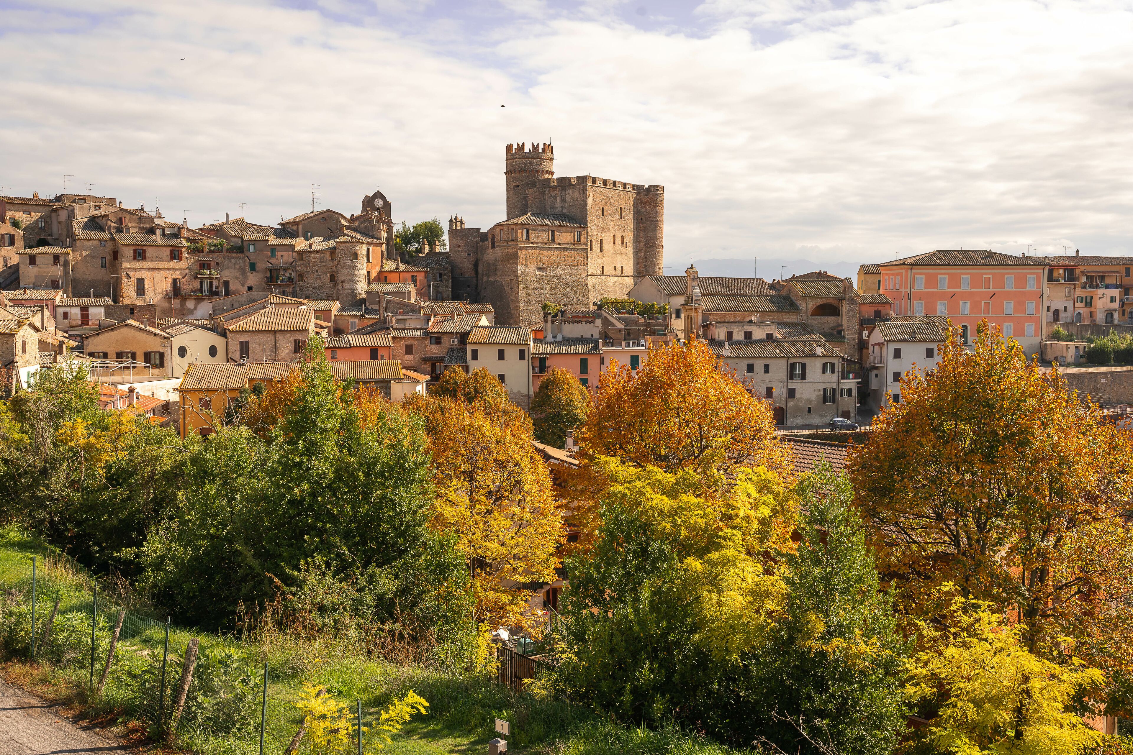 Bright autumn view with yellow and orange trees to medieval town of Nazzano in Lazio in Italy