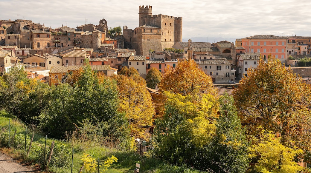 Bright autumn view with yellow and orange trees to medieval town of Nazzano in Lazio in Italy