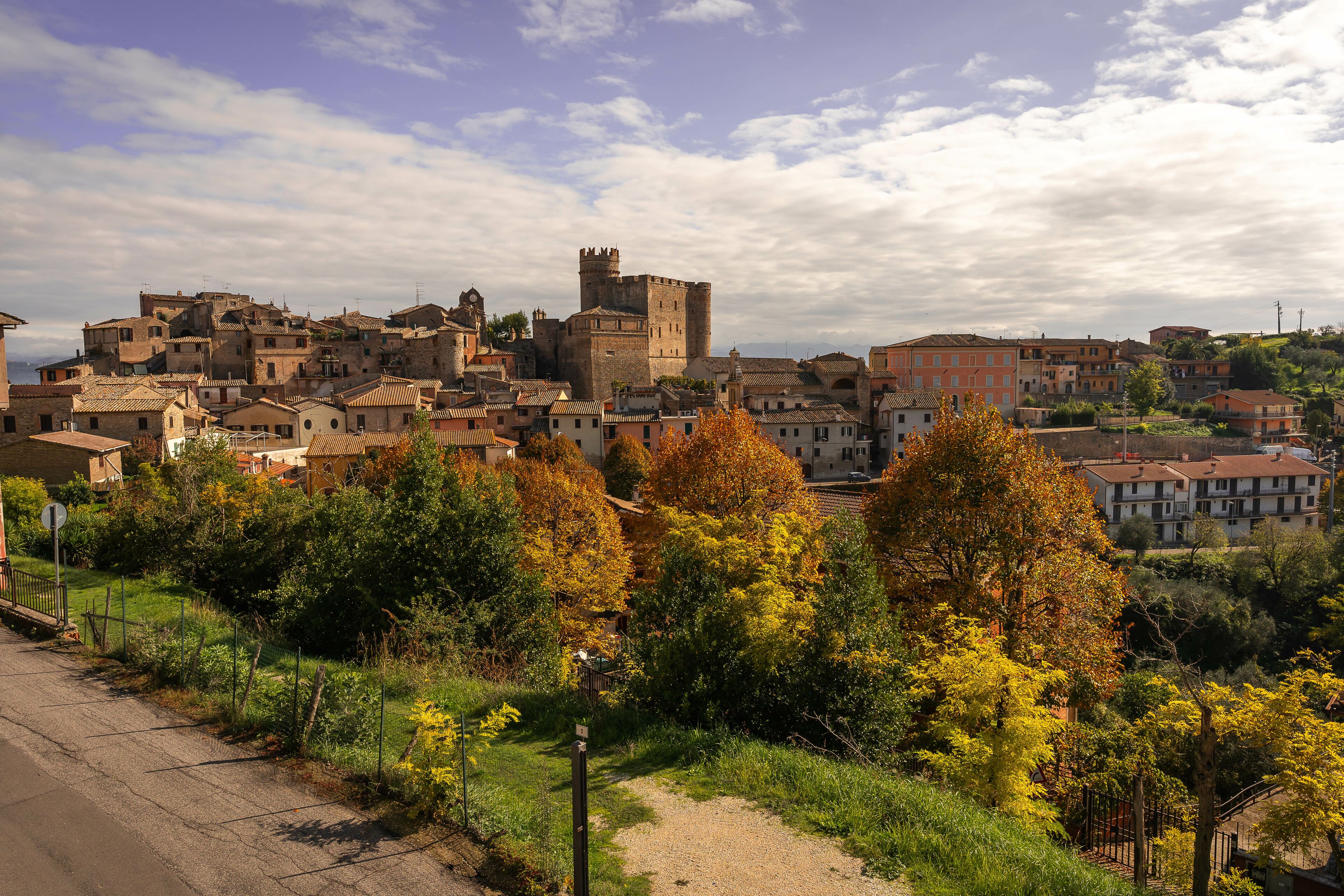 Bright autumn view with yellow and orange trees to medieval town of Nazzano in Lazio in Italy