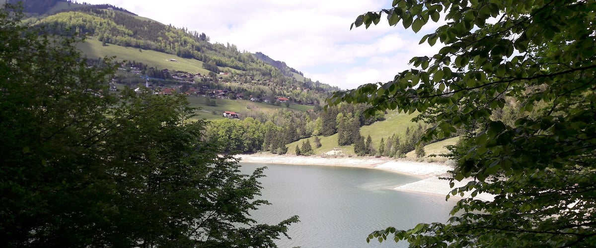 A lake surrounded by hills and trees.