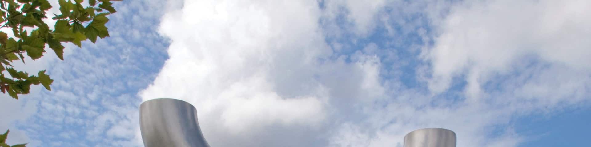 The Caryatid Gateway features two carved stone caryatids, one male and one female, each representing different aspects of Wednesbury history. The female figure represents Ethelfleda, daughter of King Alfred, who fortified Wednesbury against the Danes. The male figure represents a tube maker, Wednesbury being famous for the manufacture of tubes, the process having been patented in the nineteenth century by Cornelius Whitehouse. The tube reference is continued in the polished stainless steel inverted tubular arch 'carried' by the caryatids.