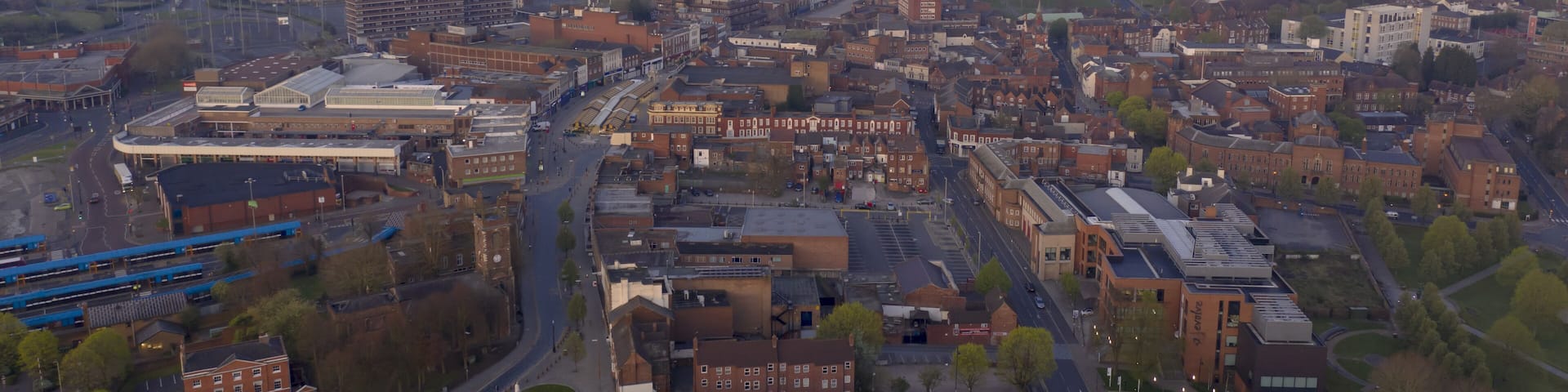 Dudley town centre at sunrise with pink clouds and quiet streets aerial