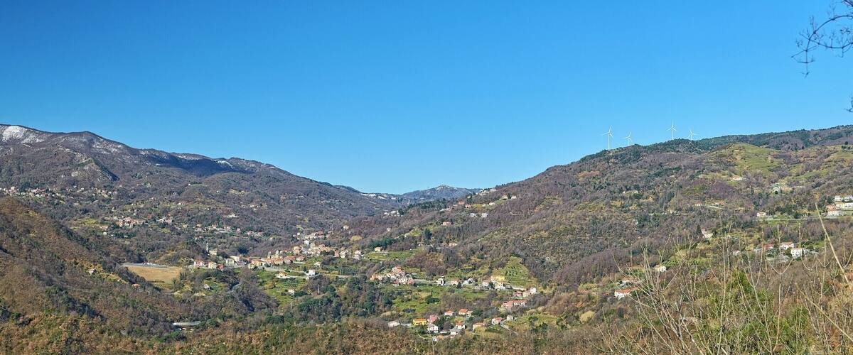 A mountainous landscape with a village nestled in the valley.