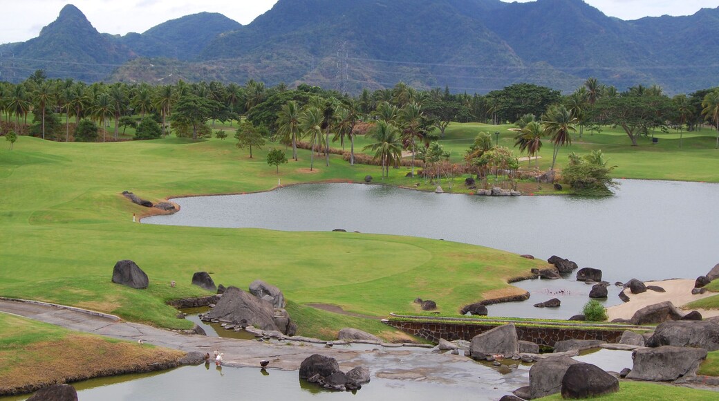 Golf course with trees, mountain, and lake at Mount Malarayat in Lipa, Batangas, Philippines
