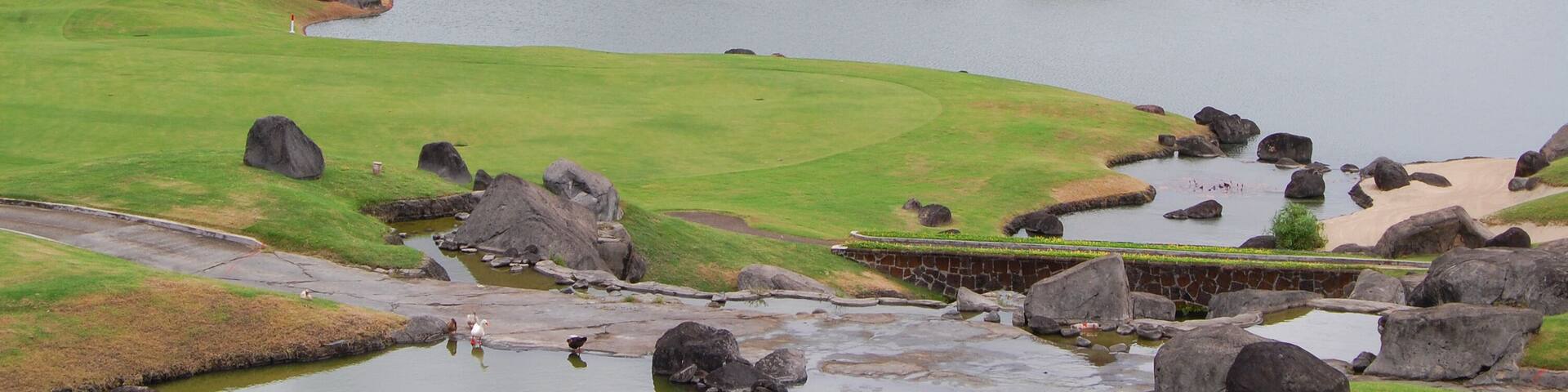Golf course with trees, mountain, and lake at Mount Malarayat in Lipa, Batangas, Philippines