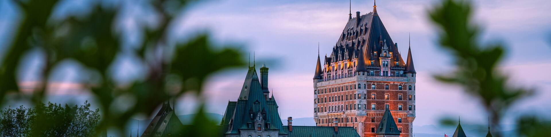 Nice view over the famous Chateau Frontenac hotel in the background, under the dusk light, blurred foreground. Old Quebec city, Canada