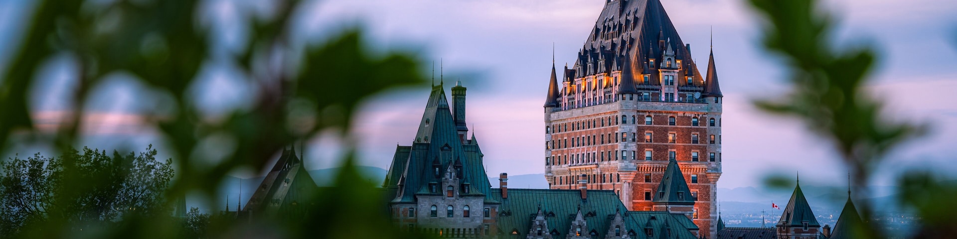 Nice view over the famous Chateau Frontenac hotel in the background, under the dusk light, blurred foreground. Old Quebec city, Canada