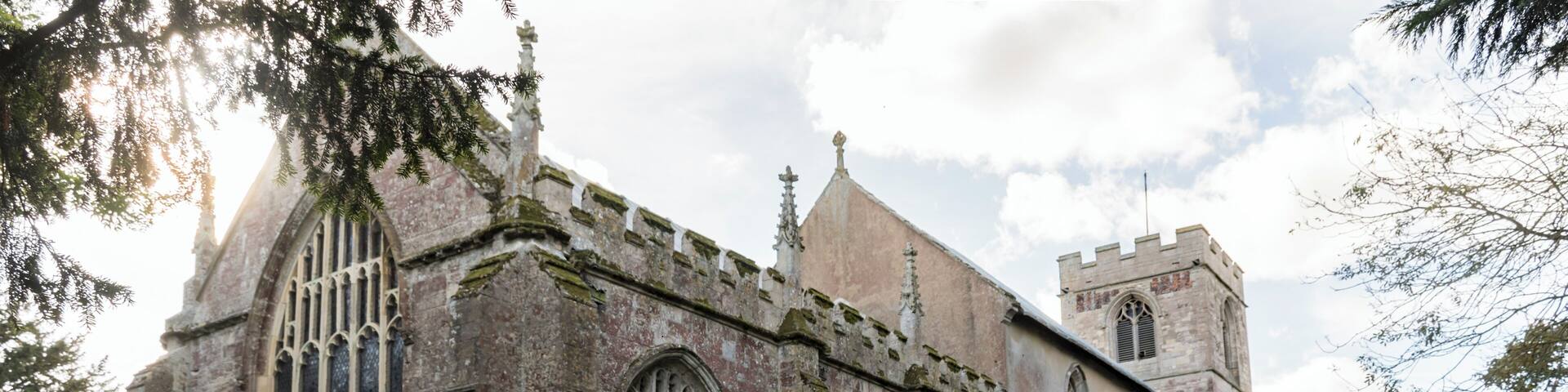 The present church is medieval and has changed little since about 1450 although there are remains of a church from 1135 which was destroyed by fire at the base of the tower. 1247 was when the foundation stone of the present church was laid and several original features of this time remain, the lower middle part of the tower, a winding staircase which would have provided access to the rood screen, a squint which would have originally been on an outside wall to allow the “unclean” and excommunicated to watch the consecration at the altar and several other features such as tomb stones. In the early 1300’s the church was altered with Sir Walter Friskney, a judge at the Court of the Exchequer in the reigns of Edward III and Richard II, being the benefactor. The nave was heightened by the addition of the clerestory and a third level was added to the tower. The chancel was also enlarged. The sedilia is late 14th century. The clerestory was decorated with wall paintings in 1320 and they can still be seen, although very faint (with the exception of The Last Supper, which was restored in 1978 at a cost of £1000). The north and south aisles were built in the 15th century and nave arches replaced the walls. The upper part of the tower now had a belfry added too plus the chancel and chapel screens were erected. The font is 15th century and originally had an ornate stone carved cover which was so heavy it had to be lifted by a pulley system.