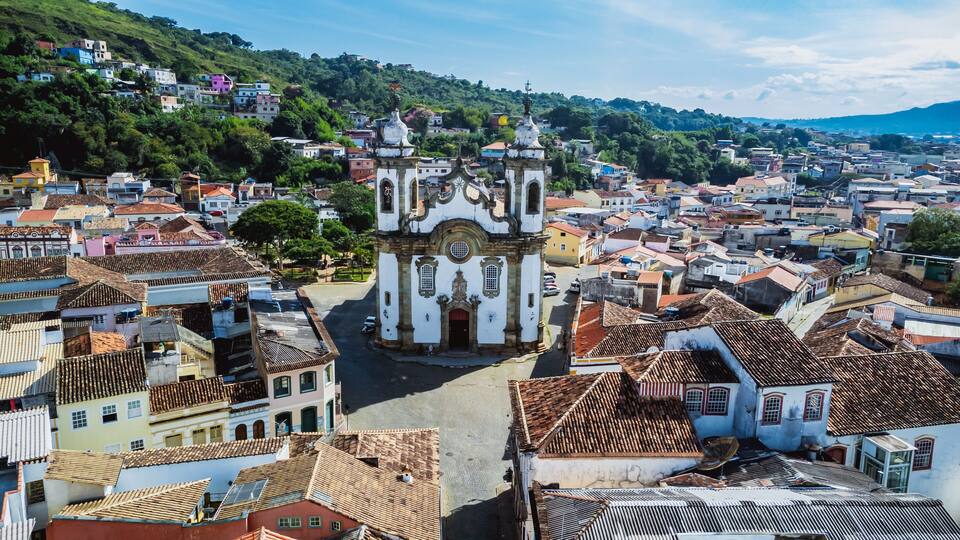 A historic town with a prominent church featuring ornate architecture and a hilltop view.