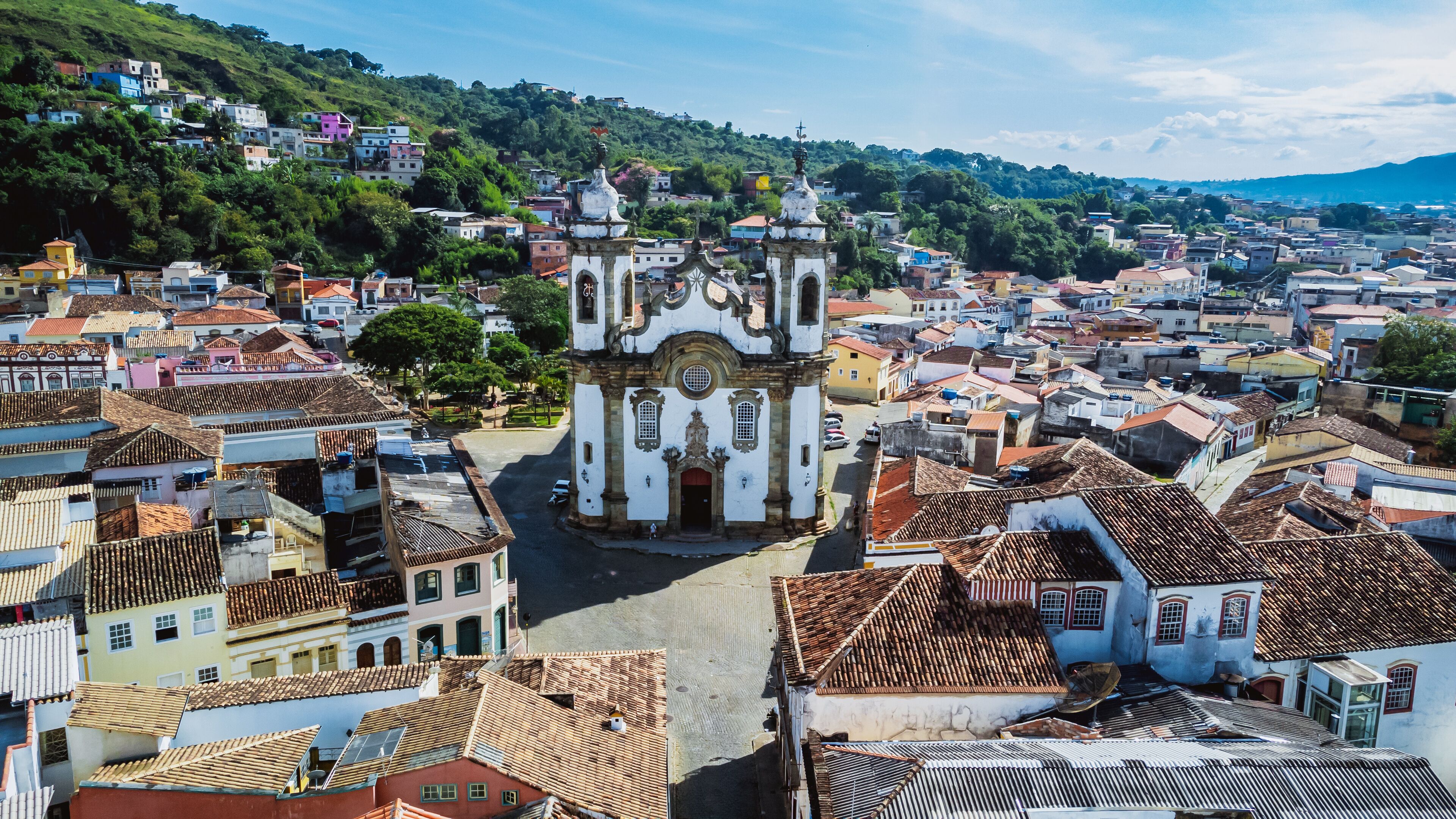 A historic town with a prominent church featuring ornate architecture and a hilltop view.