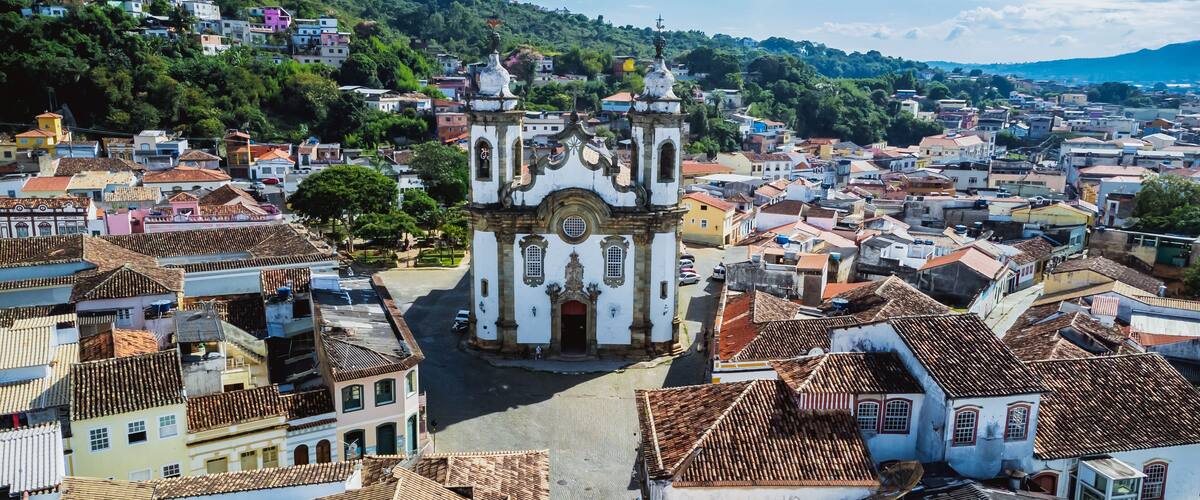 A historic town with a prominent church featuring ornate architecture and a hilltop view.