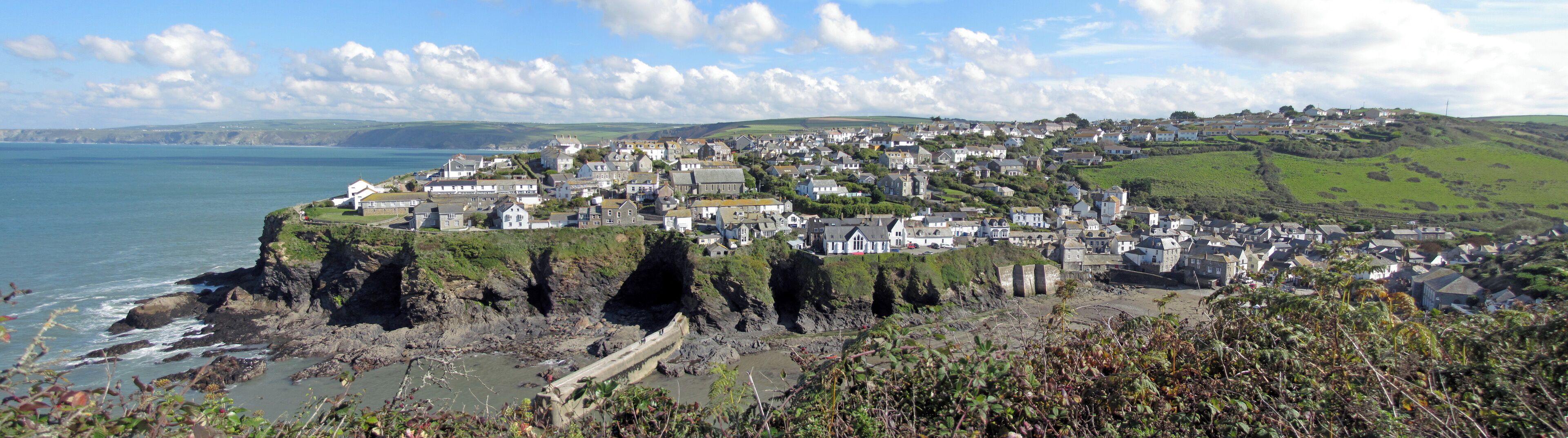 A coastal town with houses on a cliff overlooking the sea.