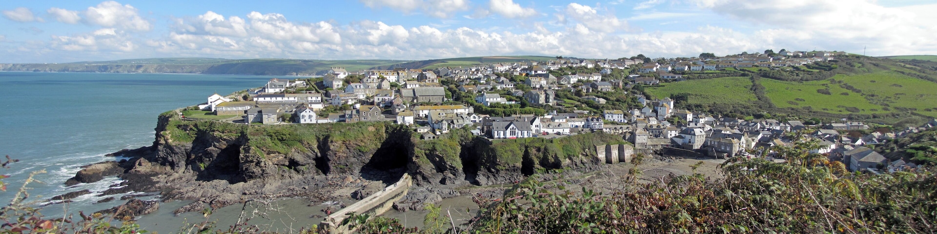 A coastal town with houses on a cliff overlooking the sea.