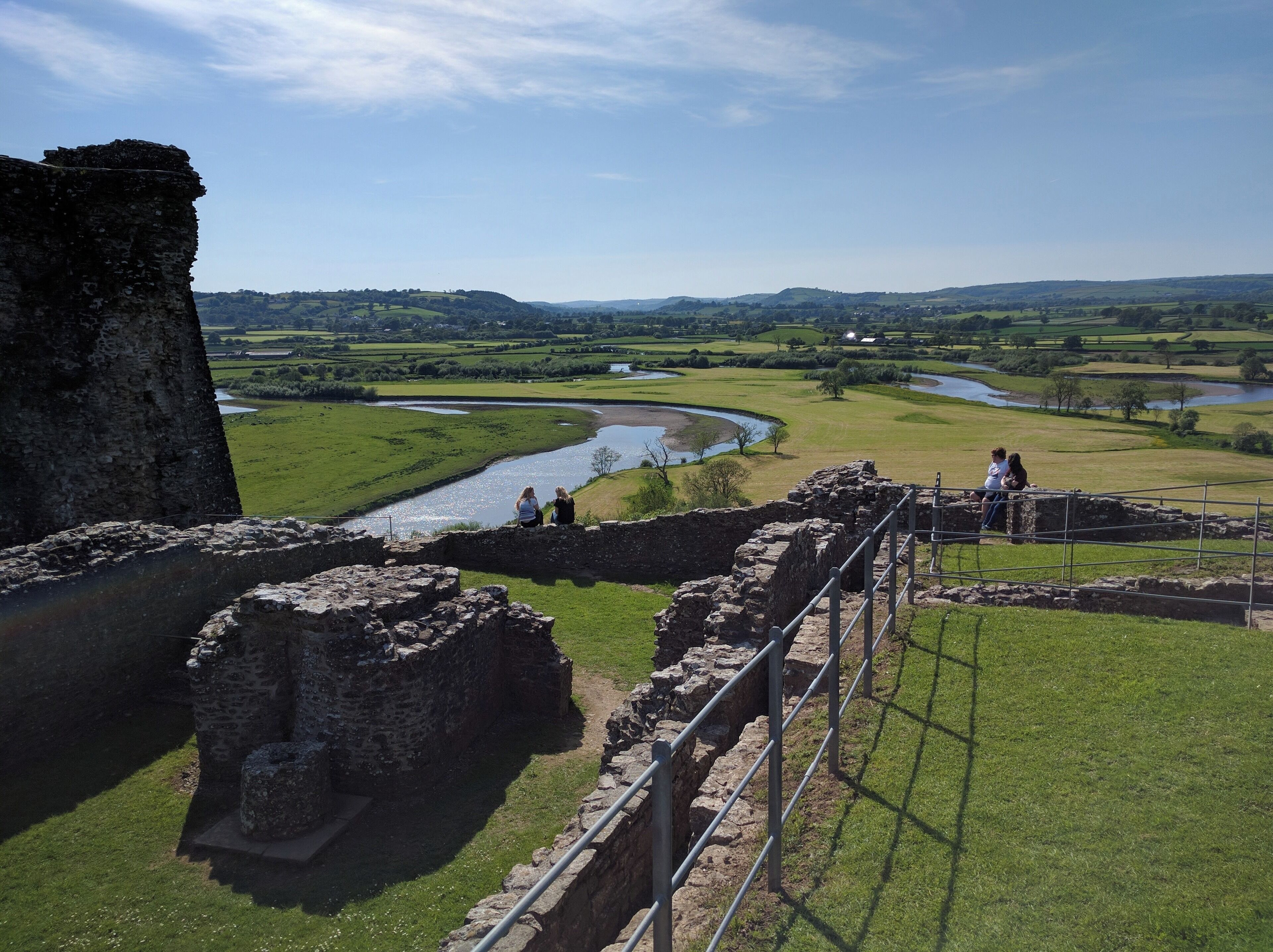 An ancient stone structure with a river in the background.