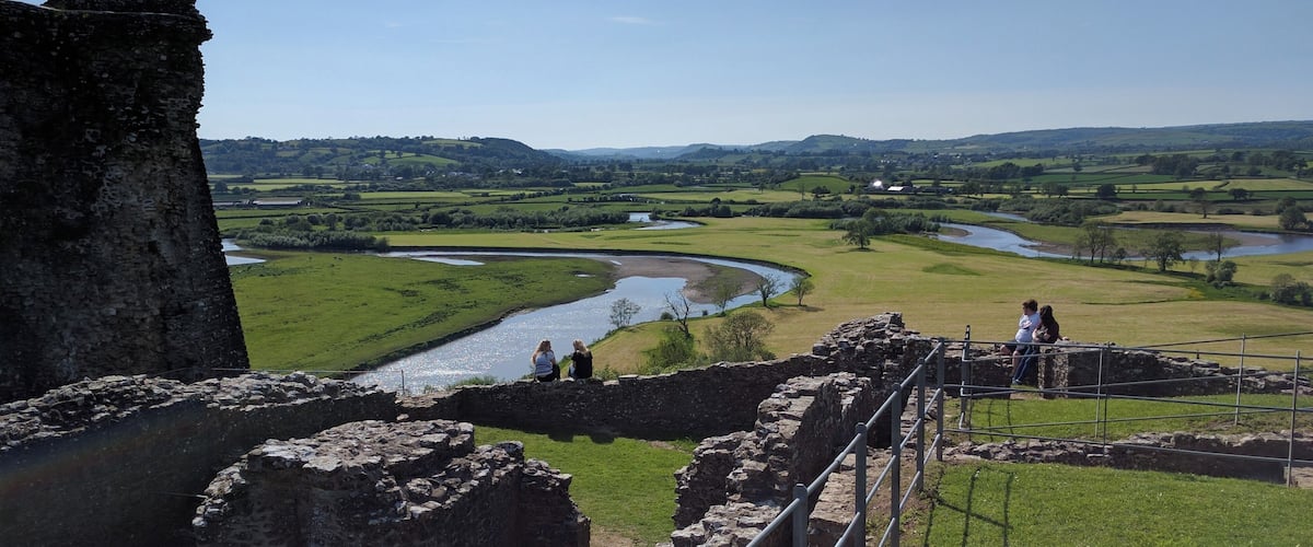 An ancient stone structure with a river in the background.