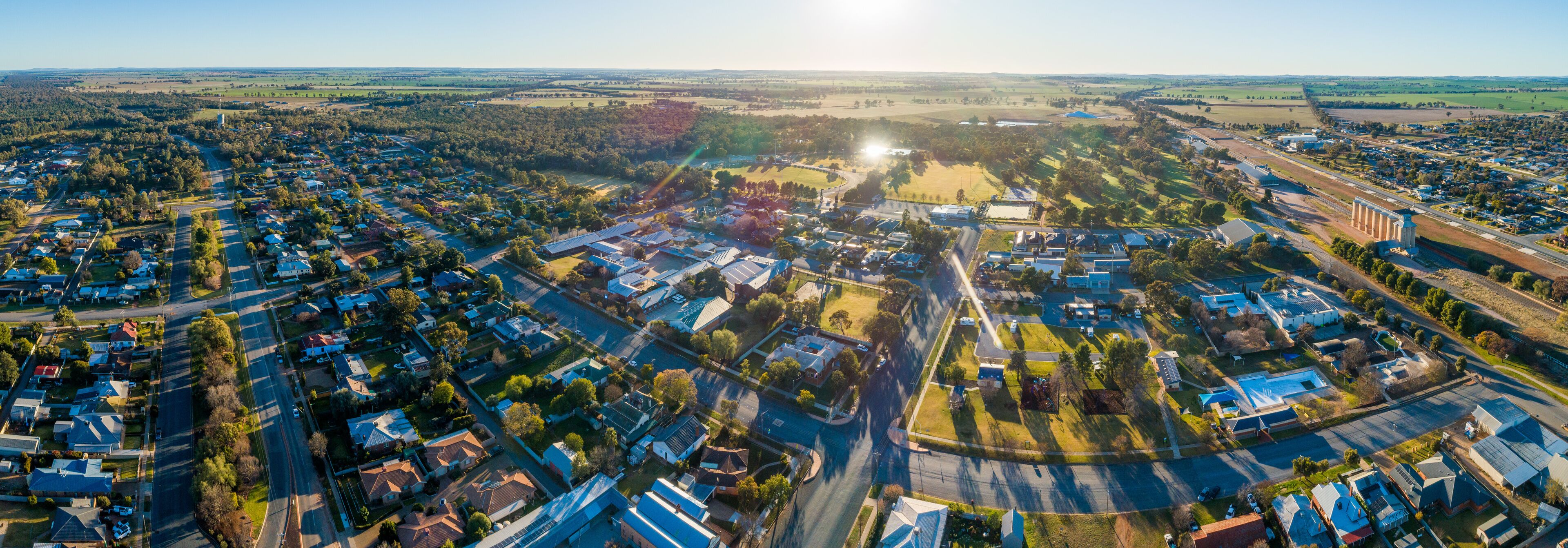 Panoramic aerial view of country town homes on sunny morning