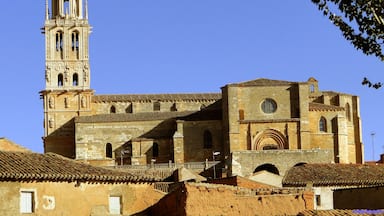A historic church with a bell tower and a large arched window.