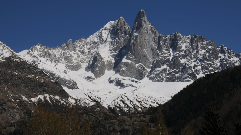 Panoramic view of Les Drus 3751m (the rocky peak in the middle) with somewhat left the snowy top of Aiguille Verte 4122m