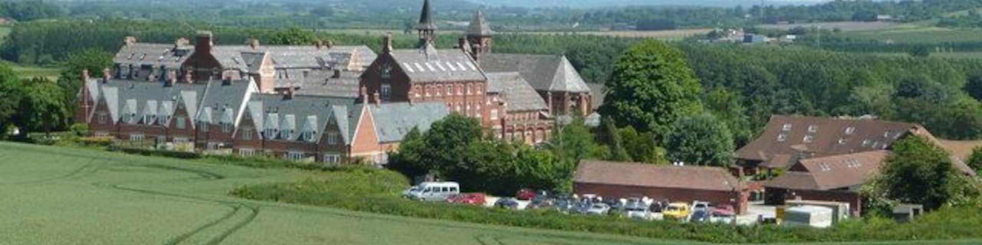Bartestree Convent and St. Michael's Hospice The main convent buildings closed as a convent in 1992 and are now flats and apartments. The newer buildings to the right are those of St. Michael's Hospice, a charitable organisation which specialises in respite and end-of-life care. See; http://www.st-michaels-hospice.org.uk/ The view is east from Longworth Lane with the Malvern Hills in the far distance.