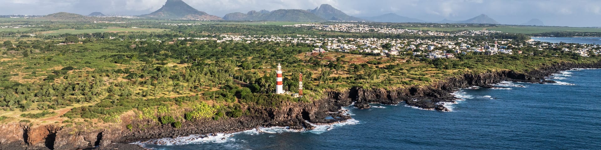 aerial landscape view of Mauritius west coast between Pointe aux Sables and Albion with deep cliffs and pointe aux caves lighthouse - aerial view