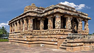 Entrance of Durga temple with blue sky and clouds, Aihole, Karnataka, India.